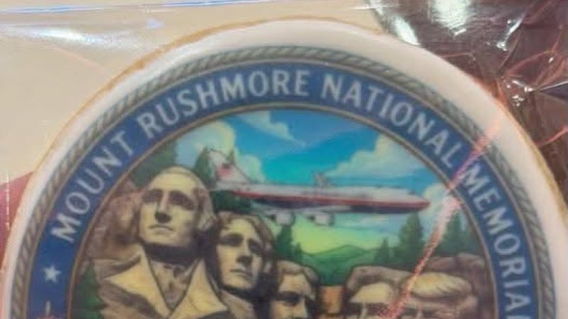Trump Used America's 250th Birthday to Campaign for His Face on Mount Rushmore — He Posted a Gold Video of Himself Carved into the Monument, the White House Said He'd Be "No Better Addition," He Distributed Cookies on Air Force One Depicting Himself as the Fifth President on the Mountain, and He Flew the Qatari Jet Over the Sacred Lakota Site While Hailstorms Battered the Crowd Below